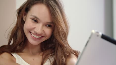 happy woman taking selfie photo on tablet computer. smiling girl posing at home