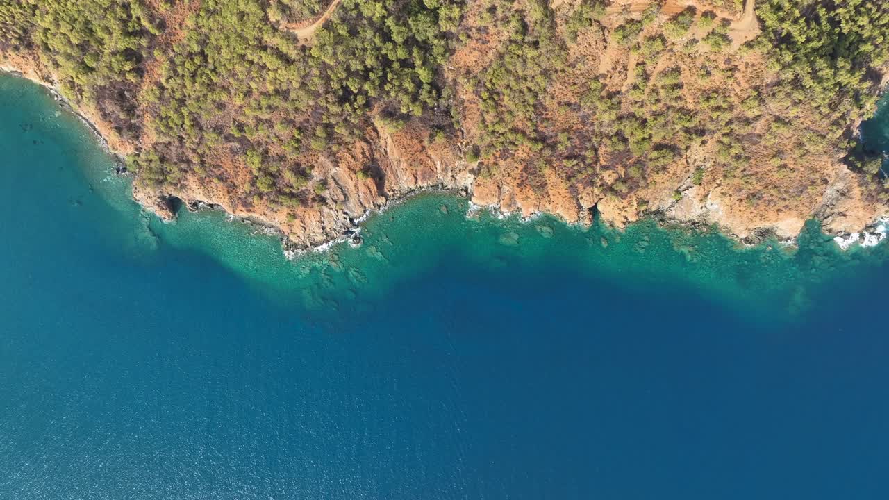 Aerial View of Coastal Cliff and Turquoise Water