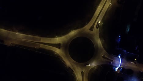 aerial static night drone shot of an roundabout in a main access to a small country town in southamerica