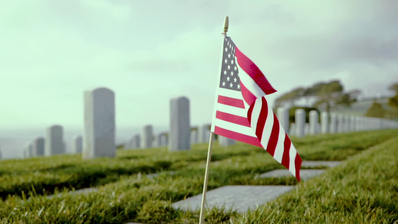 Closeup of American Flag put in the ground at a military cemetery in San Diego, blowing in the wind