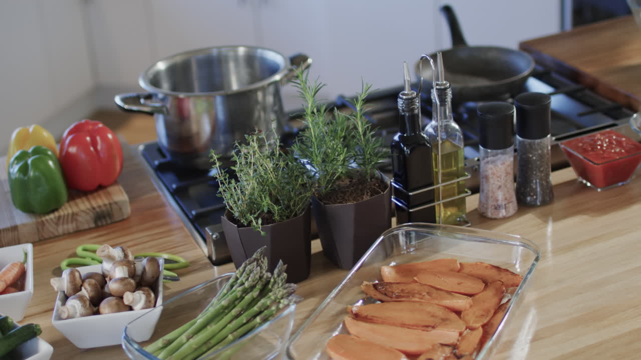 General view of kitchen countertop and hob with spices and utensils with copy space