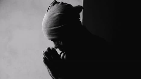 man-praying-to-god-with-hands-together-Caribbean-man-praying-with-background-with-people-stock-video-stock-footage