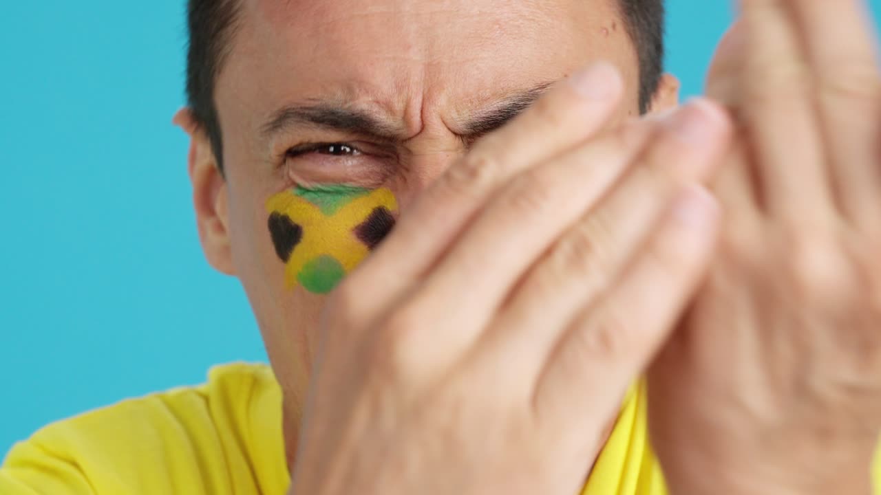 Man with jamaican national flag upset with a referee