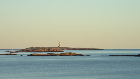 lille torungen lighthouse and islands, summer sunset in agder, norway - pan view