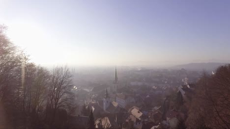 Moody-aerial-in-fog-and-clouds-of-a-small-village-in-Slovenia