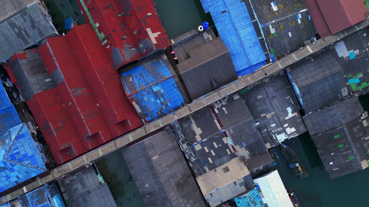Aerial view of the colorful stilt houses of bang bao pier in koh chang, thailand, showing poverty and overpopulation. Best aerial view flight rotation to right drone camera pointing down