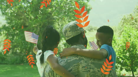 animation of leaves over back view of african american soldier father holding kids with usa flags