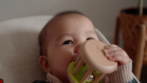 Cute-Asian-baby-smiling-and-laughing-playing-with-rattle-toy-teething