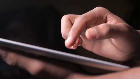 close-up of a person's hand using a tablet