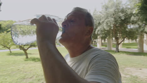 happy sportsman drinking mineral water