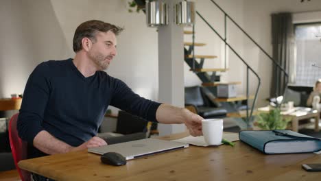 handsome man at home closing laptop