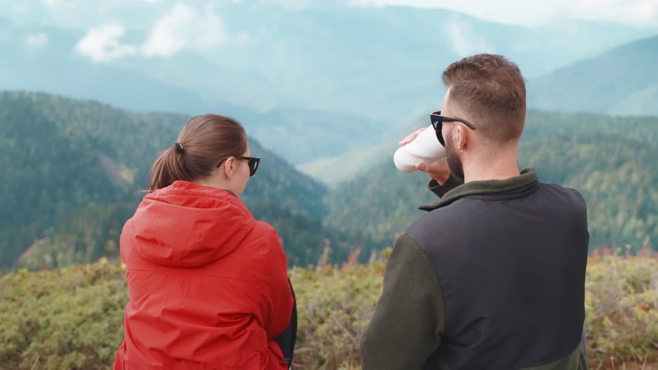 Couple enjoying coffee at a mountain view