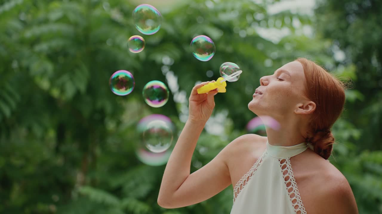 Woman Blowing Bubbles in a Park