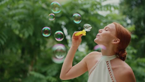 woman blowing bubbles in a park