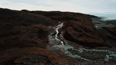 aerial push in on greenlandic waterfall by the icecap and point 660, outside kangerlussuaq