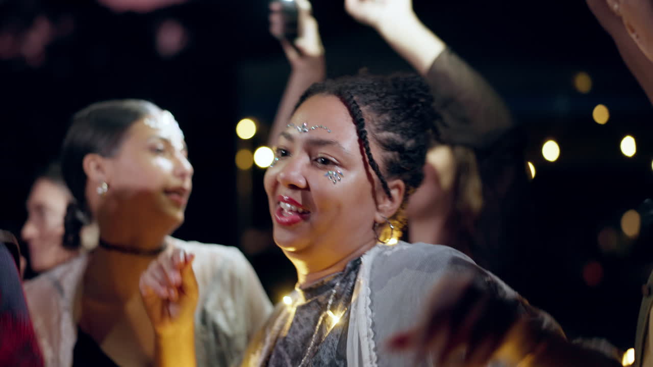 Festival, night and outdoor with woman dancing