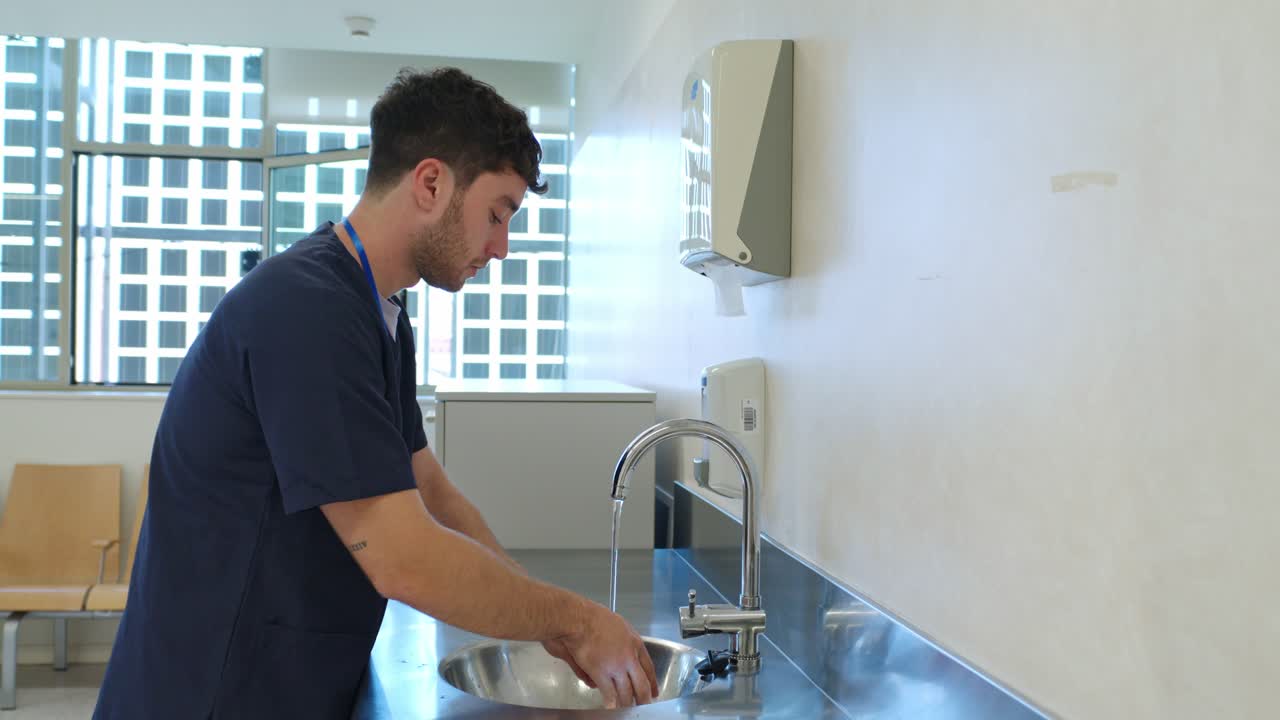 Man Washing Hands in a Hospital Setting