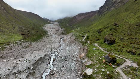 Aerial-drone-fly-view-at-the-top-of-Salkantay-trek-from-Cusco-to-Machu-Picchu-in-the-Peruvian-Andes-during-a-sunny-and-foggy-morning,-Peru,-South-America,-The-way-on-Salkantay-trek,-Peru