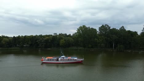 long-shot-on-sailing-boat-on-lake-water-near-forest-poland-europe-aerial