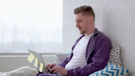 man working from home in pajamas
