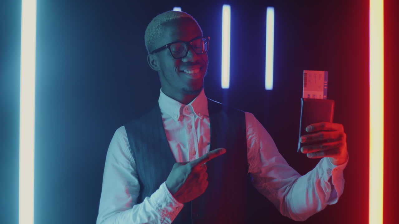 Man Holding Boarding Pass in Neon Lights