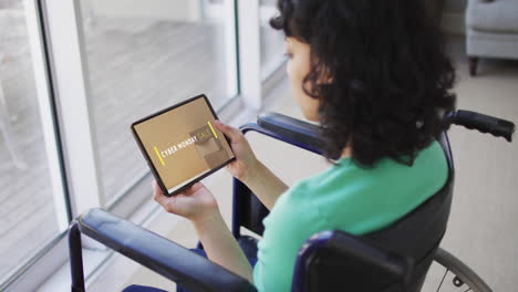 Biracial woman in wheelchair using tablet, online shopping on cyber monday, slow motion