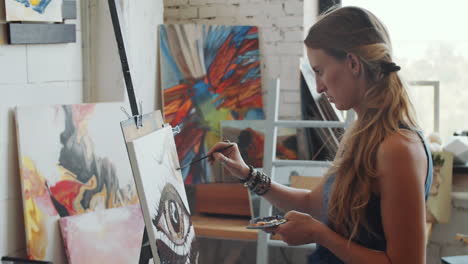 woman artist painting in a studio