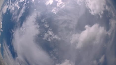 blue sky and layer of clouds moving about in a fine sunny afternoon