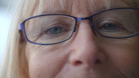 close up of senior woman's face blinking and smiling