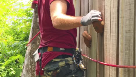 person climbing wooden wall