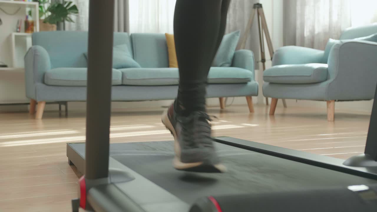 Front View Legs Of Asian Woman Running On A Treadmill At Home
