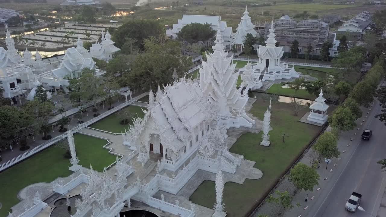 Thailand,Chaing Rai,White Temple, Drone footage of the white temple's whole complex with a perfect angle early in the morning. Footage moves slowly from right to left turns around the temple complex.