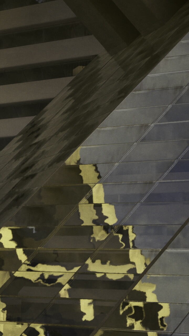 Reflection of buildings on glass surface at cityscape