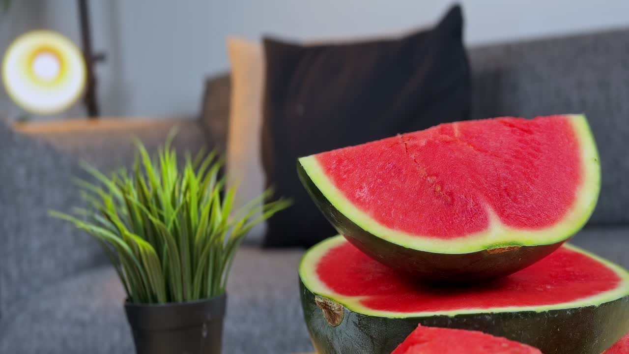Freshly cut watermelon slices on a table with a modern living room background, perfect for food, lifestyle, health, and advertising projects