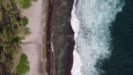 A-fly-over-a-beautiful-beach,-lagoon-and-coral-reef-in-Reunion-Island