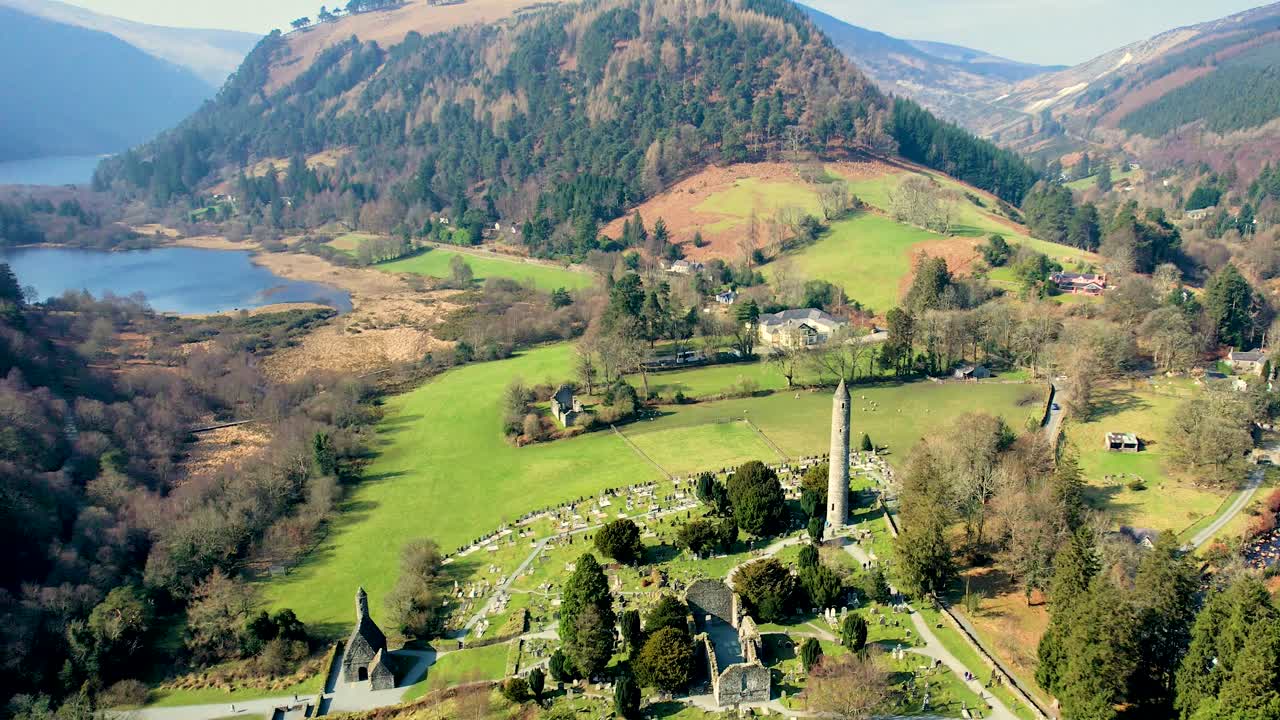 A steady drone shot 4oo feet above of the Glendalough valley and graveyard