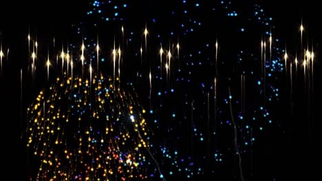 Animation-of-gold-stars-with-colourful-christmas-and-new-year-fireworks-on-night-sky