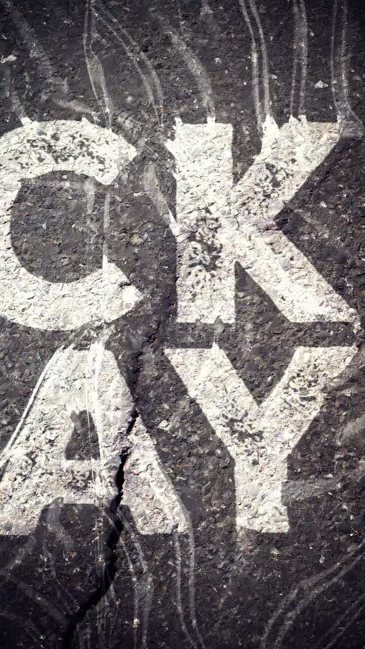 Black Friday Text Appearing on Dark Asphalt Surface