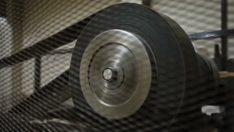 industrial machine pulley and belt system in motion