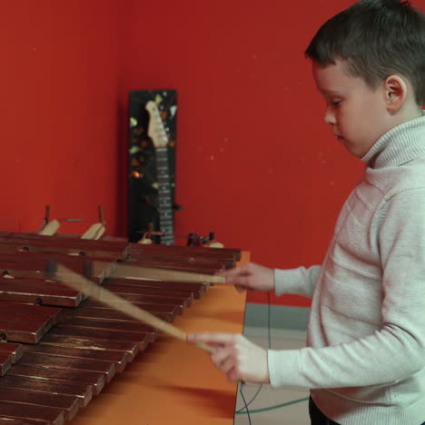 boy playing on xylophone. square video