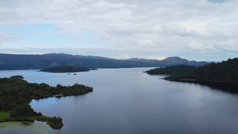 ariel drone view of island in loch lomond on cloudy day