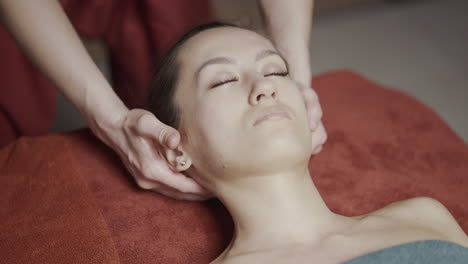 woman receiving a facial and neck massage