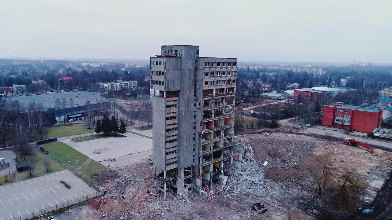 Partial ruins of former electronics factory tower standing in quiet urban zone