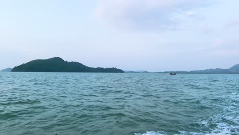 landscape view of the sea ocean in early morning with sunrise in summer daytime while on the moving boat