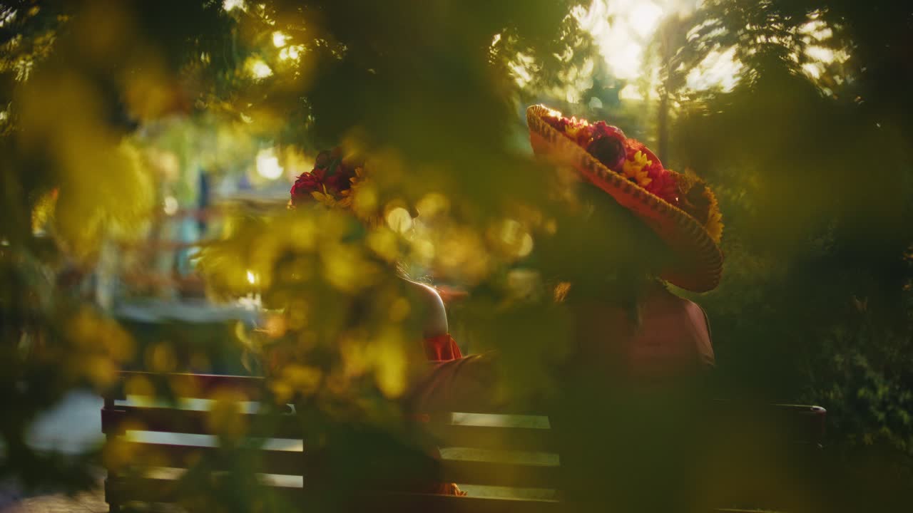 Couple in Day of the Dead Costumes in a Park at Sunset