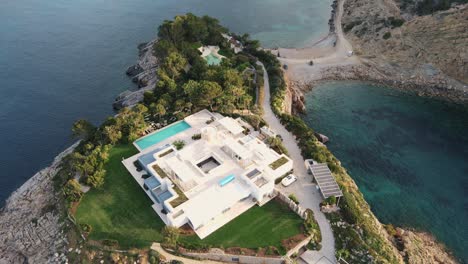 private-wealthy-home-on-island-in-cala-benirras,-ibiza-aerial-overhead-view