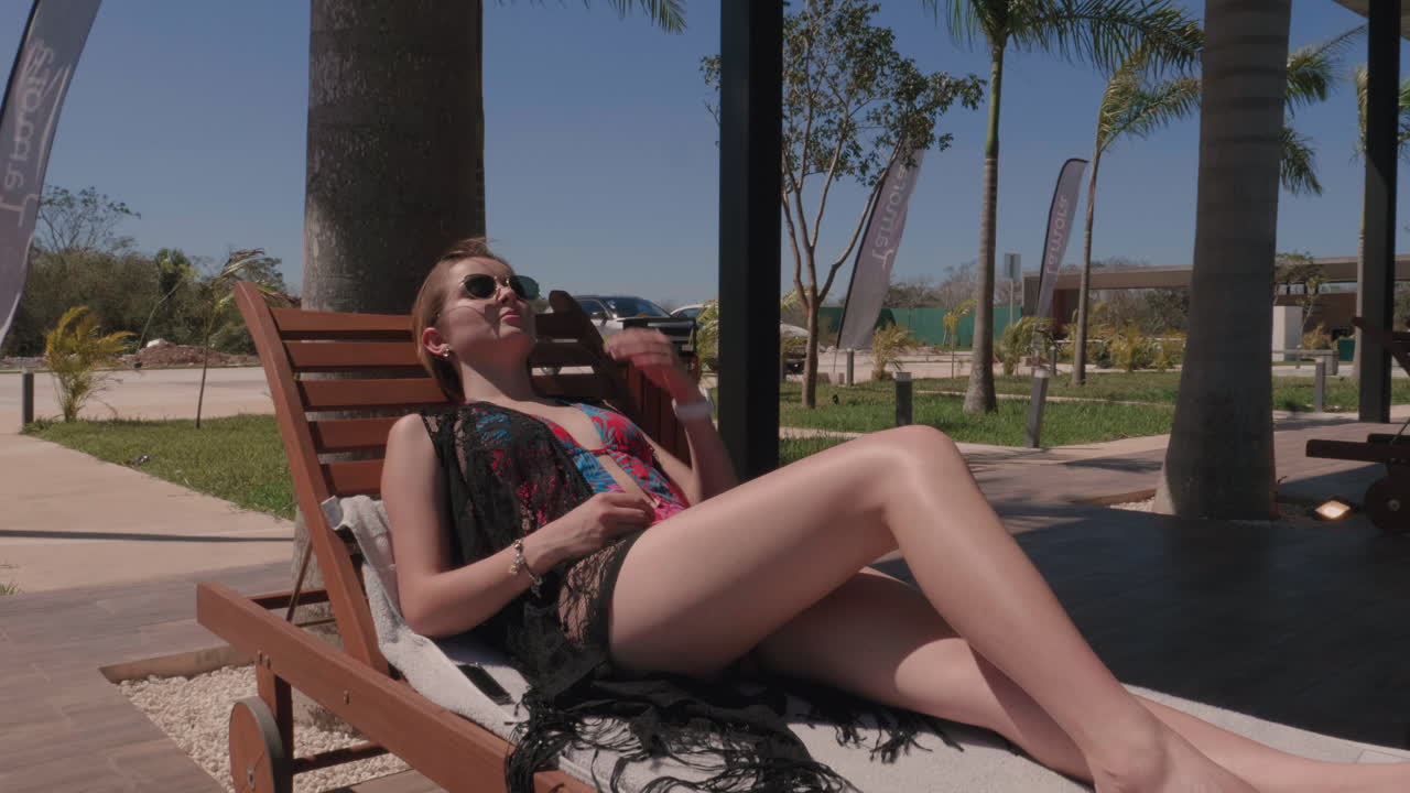 Beautiful Woman Sunbathing In Bathing Suit On A Sun Lounger slow motion