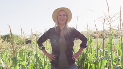 Video-of-happy-caucasian-woman-standing-in-field-on-sunny-day