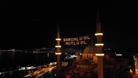 aerial night view of new mosque. there says " be responsible, be happy"