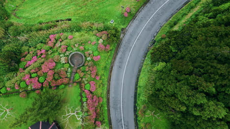 curved road crossing grassy hills drone top view. highway at asphalt mountain